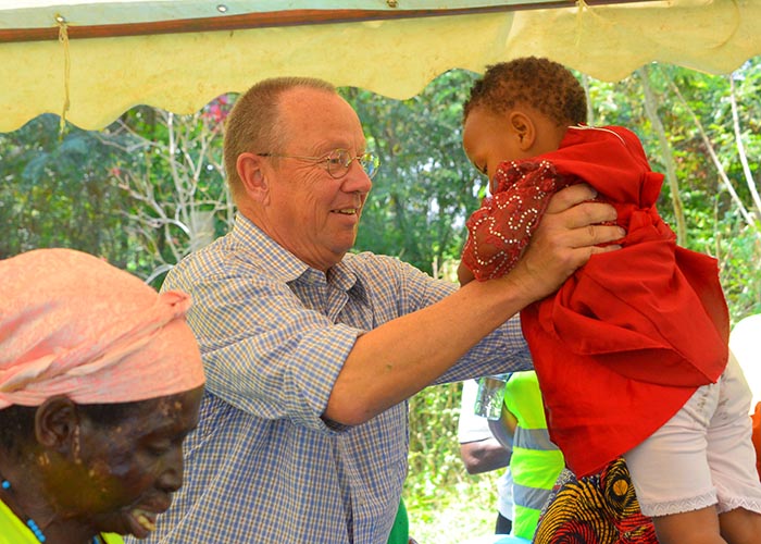 Claus Ollerking interacting with a baby